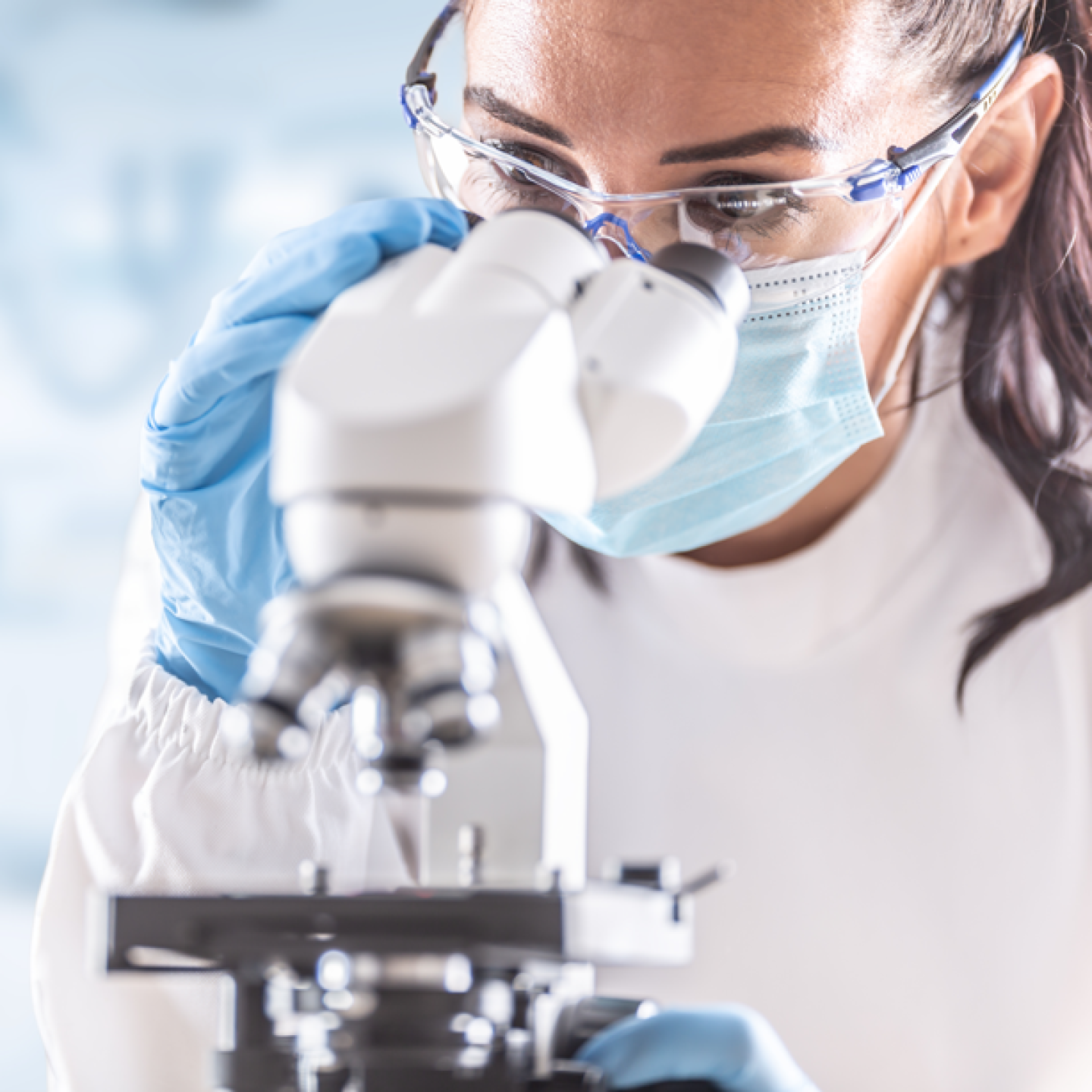 Female-Lab-Technician-Looking-into-Microscope